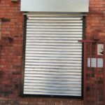 Red double doors with closed GJ Roller Doors shutter